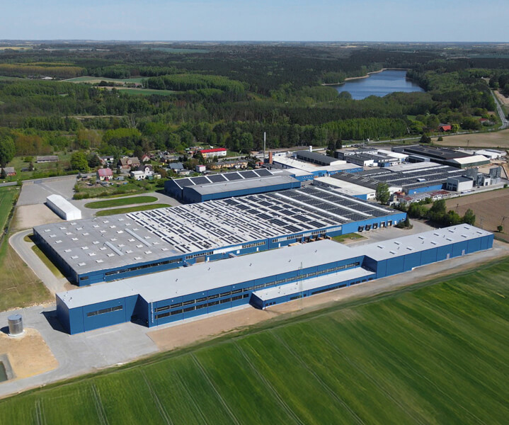 Aerial view of a modern office furniture factory surrounded by greenery